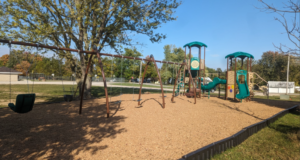 The main playground at Maugans Park that includes 6 swings and a climbing area