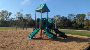 Maugans kids play area (back playground) which includes two swings and climbing area with slides