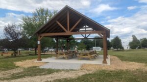 Maugans Park pavilion, a wooden struture with a roof with picnic tables underneath