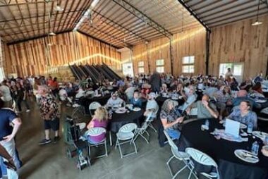 Crowded room with people sitting together at tables